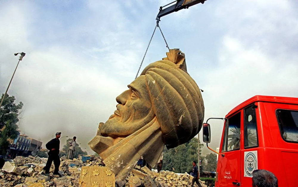 A crane lifting a statue of a person
AI-generated content may be incorrect.